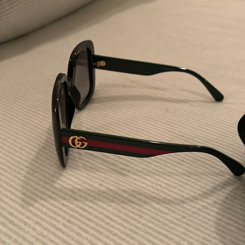 Womans used Gucci sunglasses with case.